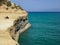 Sidari, Corfu, Greece - rocky cliff with backpacks and beautiful turquoise water