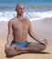 Siddhasana pose bald man beach