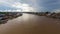 Side Aerial View of A River in Palangka Raya with houses on two sides during day time