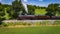 Side Aerial View of a Steam Streamlined Locomotive Blowing Smoke