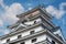 The side angle of Karatsu japanese Castle Karatsu-jo Located on hill with blue sky and clouds, Karatsu, Saga