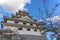 The side angle of Karatsu japanese Castle Karatsu-jo Located on hill with blue sky and clouds, Karatsu, Saga