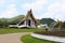 Side angle of the white Buddhist temple with dragon fountains and a pathway at Ban Nong Thailand.