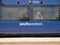 The side of a blue southeastern Railways carriage. Behind one of the two windows, commuters sit