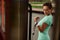 Side close-up portrait of an attractive sportive woman of Hispanic ethnicity doing exercise on biceps with stationary outdoor