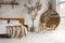 Side closeup view on spacious white eco style loft bedroom with bed,  mirror and pampas grass decoration