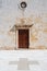 Side entrance of catholic church in Croatia with stone paved forecourt