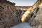 side entrance to the film set from the 1980 musical Popeye in Malta, now a theme park village with boat rides and food outlets