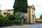 Side facade wall of a church in Vecchiano on the road between trees and plants