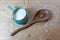 Side handle bowl pitcher of almond milk, large carved wooden spoon with single almond