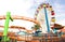 Side horizontal view of multicolored ferris wheel at Santa Monica Pier at Pacific Amusement Park - Los Angeles