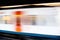 Side ivew of Defocused view of metro train arrival in station platform with no