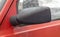 Side left black plastic rearview mirror on a red car. Exterior side view mirror on the drivers side on an old car