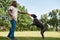 Side of man training Kurzhaar dog catching ring