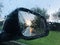 Side mirror in the car, dangerous driving, poor visibility in rainy weather