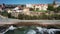 Side panning of people on Cascais to Estoril promenade with waves crashing