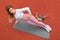 Side plank fitness exercise. Top view of athletic young girl doing workout, planking, bodyweight exercise for core