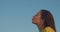 Side portrait of defocused girl kissing moon in blue sky. Profile of Caucasian woman out of focus outdoors copy text