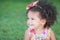 Side portrait of a small hispanic girl with an afro hairstyle