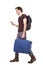 Side portrait of traveler walking with suitcase and mobile phone