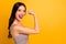 Side profile close up photo of cheerful strong powerful woman demonstrating her triceps elbow near empty space with lips