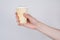 Side profile cropped close up photo of hand getting holding sharing taking waffle cup with ice cream isolated grey background