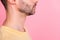 Side profile cropped photo of serious positive man stylish haircut yellow t-shirt look empty space isolated on pink