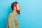 Side profile photo of bearded confident guy with ginger hairstyle khaki long sleeve look empty space isolated on teal