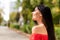 Side profile photo portrait of cheerful woman smiling wearing stylish red dress enjoying windy summer weather fresh air