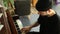 Side profile view of young man sitting on an old classic piano and playing some tunes