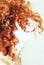 Side profile of woman with curly red hair
