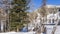 On the side of the road, trodden in a snow-covered forest, there is a curved lattice fence