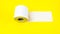side roll of toilet paper on yellow background