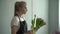 Side shooting of young woman florist making floral bouquet from fresh tulips.