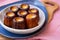 A side shot of a small plate of CanelÃ©s de Bordeaux