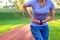 Side stitch - woman runner side cramps after running. Jogging woman with stomach side pain after jogging work out. Female athlete