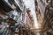 Side street in industrial zone with wires, tubes and air conditioners