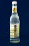 Side view of 500ml non-alcoholic Fever-Tree Ginger Beer glass bottle isolated blue background