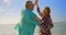 Side view of active senior Caucasian couple dancing on the beach 4k