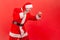 Side view aggressive purposeful gray bearded man holding fists up, fighting with competitors, pretending to be santa claus, fight
