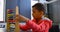 Side view of Asian schoolboy solving math problem with abacus at desk in a classroom at school 4k