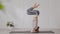 Side view of Asian woman doing Yoga exercise in front of windows,Yoga HandStand pose or Pincha Mayurasana,Calm of healthy young