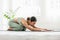 Side view of Asian woman wearing green sportwear doing Yoga exercise,Yoga Childâ€™s pose or Balasana,Calm of healthy young woman