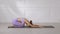 Side view of Asian woman wearing purple sportwear doing Yoga exercise,Yoga Childâ€™s pose or Balasana,Calm of healthy young woman