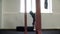 Side view of athletic man flipping tyre during workout in gym