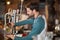 Side view of bartender making drinks