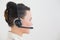 Side view of a beautiful businesswoman using headset