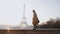 Side view beautiful happy tourist woman walking, dancing at romantic sunrise Eiffel Tower scenery in Paris slow motion.