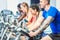 Side view of a beautiful woman smiling while cycling during spinning class