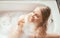 Side view beautiful young woman drinking champagne and keeping eyes closed enjoying bubble bath